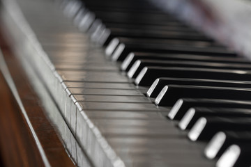 Antique piano keys and wood grain. Closeup, selective focus