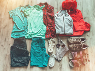 Set necessary clothes for female hiking: shorts,pants,trekking socks, thermal top, t-shirts,fleece jacket, boots, sandals