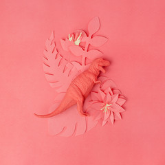 Color of year 2019 Living Coral concept. Tirannosaur dinosaur toy and origami papercraft flowers...