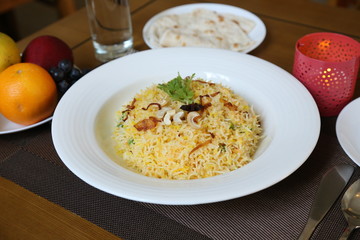 Vegetable briyani on white plate with lights