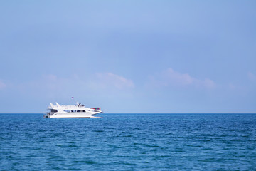 Fototapeta na wymiar A white pleasure boat on the sea.
