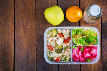 Lunch box  chicken, broccoli, green peas, tomato  with rice and red cabbage. Healthy fitness food. Take away. Lunchbox. Top view