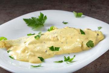 Piece of marinated herring with mayonnaise sauce