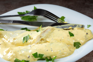 Piece of marinated herring with mayonnaise sauce