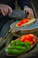 fresh vegetables on the cutting board and knife, in forest