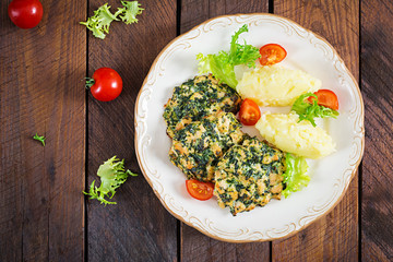 Baked steak chopped chicken fillet with spinach and a side dish of mashed potatoes. European cuisine. Dietary food. Top view