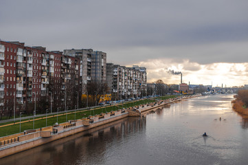 Sunrise. Old residential buildings and the river