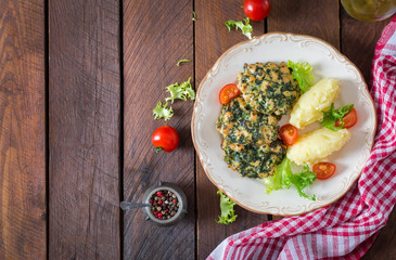 Baked steak chopped chicken fillet with spinach and a side dish of mashed potatoes. European cuisine. Dietary food. Top view