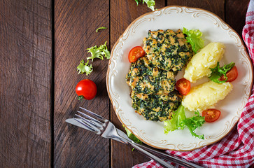 Baked steak chopped chicken fillet with spinach and a side dish of mashed potatoes. European cuisine. Dietary food. Top view