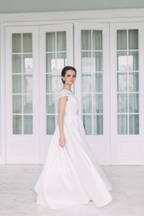 The bride in the white Studio with a bouquet. Wedding in the European style fine art.