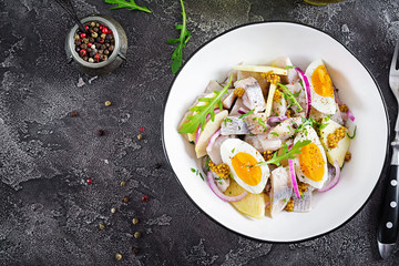Traditional  salad of salted herring fillet, fresh apples,  red onion  and eggs. Kosher food. Scandinavian cuisine. Top view. Flat lay