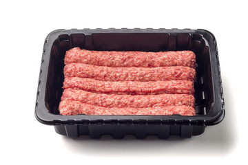 Packed raw sausages in black plastic black tray