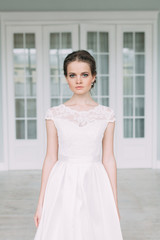 The bride in the white Studio with a bouquet. Wedding in the European style fine art.