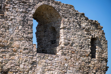 Ancient fortress close to the river or lake. Ruins of medieval castle or palace