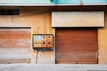 Closed rusty shutter door, old building in India
