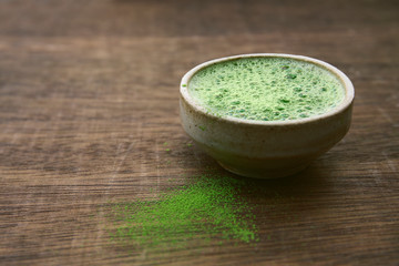 matcha green tea in a bowl on a dark background