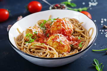 Italian pasta. Spaghetti with meatballs and parmesan cheese in bowl on dark rustic wood background.  Dinner.  Slow food concept