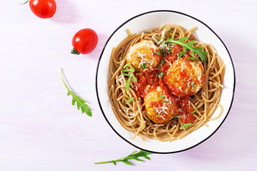 Italian pasta. Spaghetti with meatballs and parmesan cheese in bowl on light rustic wood background. Dinner. Top view. Slow food concept