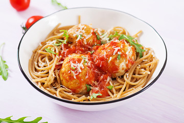 Italian pasta. Spaghetti with meatballs and parmesan cheese in bowl on light rustic wood background. Dinner. Slow food concept
