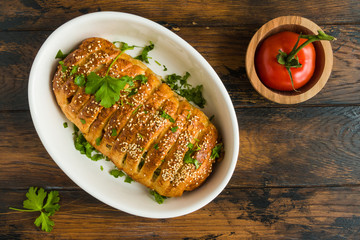 Meatloaf in dough, meat pie. White baking dish on wooden rustic table, top view