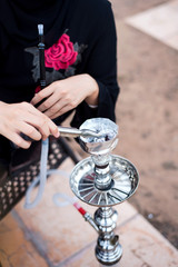 Muslim woman smoking hookah in a bar