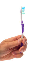 toothbrush in hand on an isolated background