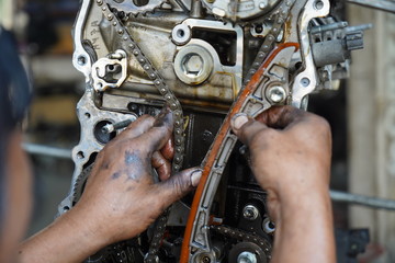 Fototapeta na wymiar Hand working on car's engine