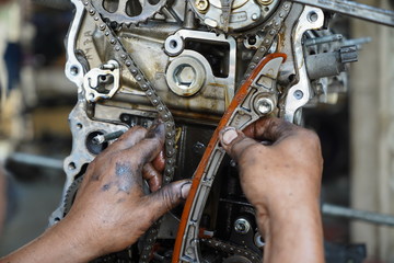Fototapeta na wymiar Hand working on car's engine