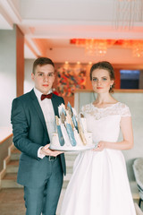 Beautiful young couple in cafe with cake. Wedding in the European style fine art.