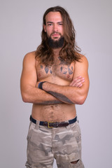 Portrait of bearded young handsome man with long hair shirtless