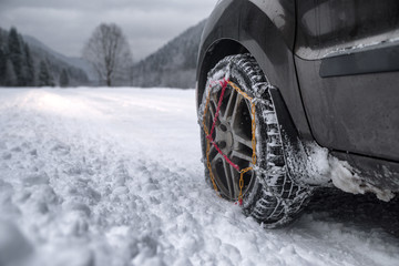 Snow chains on tire at winter road