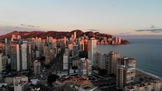Aerial photo at sunset showing the whole of Benidorm in Alicante, you can see everywhere included Playa de Levante beach, Balcón del Mediterráneo and all the high rise hotels.