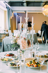 Table decor at the wedding celebration. Registration of the ceremony and the arch at the wedding.