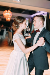 The first dance of a young couple. Wedding traditions in European style.