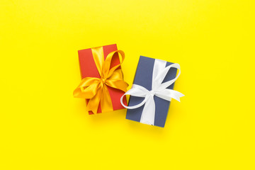 Two gift boxes on a yellow background. Holiday concept, New Year, Christmas, Birthday, Valentine's Day. Flat lay, top view.