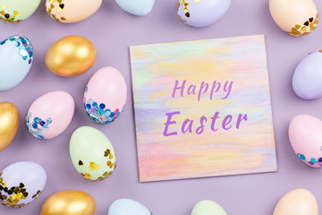 Pastel colorful Easter eggs decorated in sequins on pastel background, copy space. Happy Easter greeting card