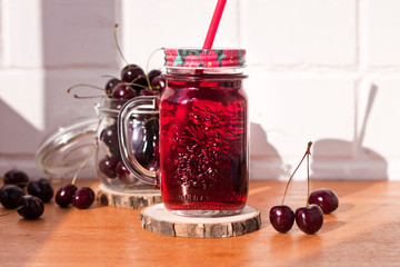 Homemade fresh cherry juice in a jar. Rustic style, healthy, organic, diet food. Selective focus.
