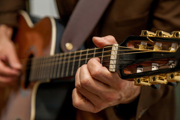 Fototapeta na wymiar musician plays guitar close up