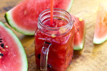 Fresh watermelon smoothie in the mason jar on wooden background. Summer,  healthy organic food concept.