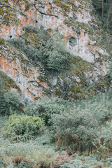 The bends of the river and the beautiful cliffs. Summer nature and texture of the stones with streaks.