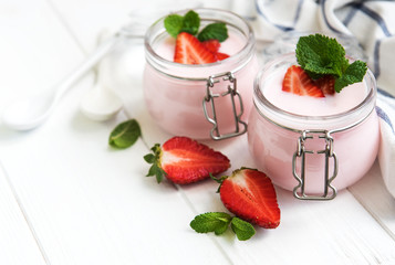 Jars with strawberry yogurt