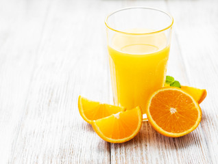 Glass of juice and orange fruits