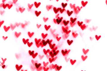 Red heart valentine bokeh lights against a white background