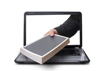 Fototapeta premium hand with book coming out of laptop