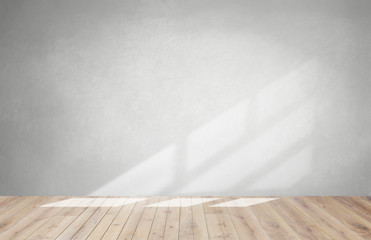 Gray wall in an empty room with a wooden floor