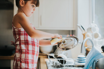 Little girl doing the dishes