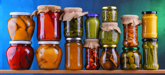 Jars with variety of pickled vegetables and fruits