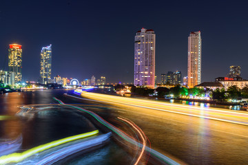 Obraz na płótnie Canvas blur light of boat moving at the river of City