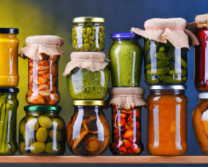 Jars with variety of pickled vegetables and fruits