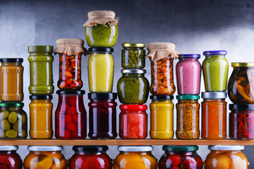 Jars with variety of pickled vegetables and fruits